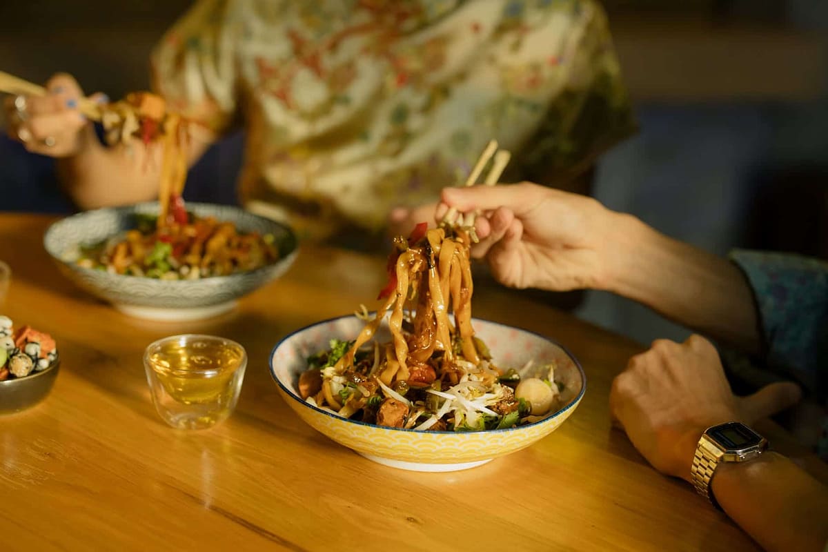 people eating noodles